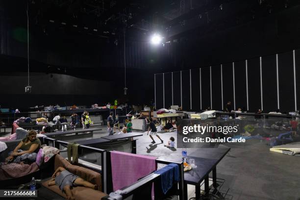 Internally displaced people socialize at a discotheque converted into an IDP shelter on October 3, 2024 in Beirut, Lebanon. Israel continued...