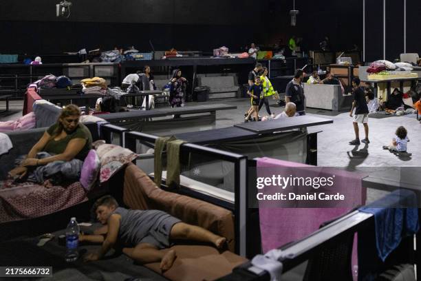 Internally displaced people socialize at a discotheque converted into an IDP shelter on October 3, 2024 in Beirut, Lebanon. Israel continued...