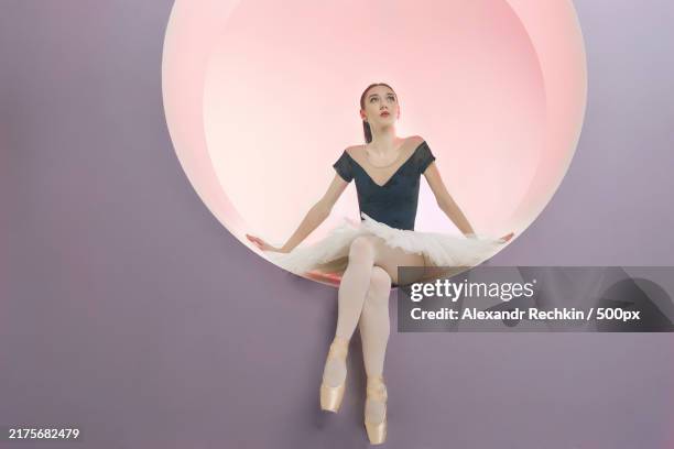 young ballerina in a white tutu sits in a ring set beautiful ballerina,novosibirsk,siberia,russia - trikot stock-fotos und bilder