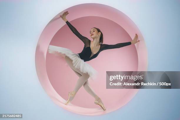 young ballerina in a white tutu poses standing in a ring set a beautiful ballerina in a circle,novosibirsk,siberia,russia - gymnastikanzug stock-fotos und bilder