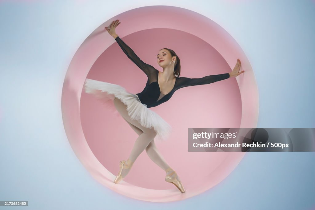 Young ballerina in a white tutu poses standing in a ring set A beautiful ballerina in a circle,Novosibirsk,Siberia,Russia