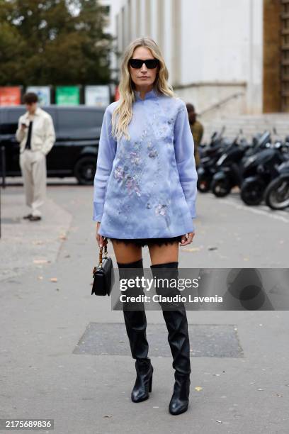 Guest wears lilac decorated mini dress, black over the knees boots, black bag, outside Shiatzy Chen, during Womenswear Spring/Summer 2025 as part of...