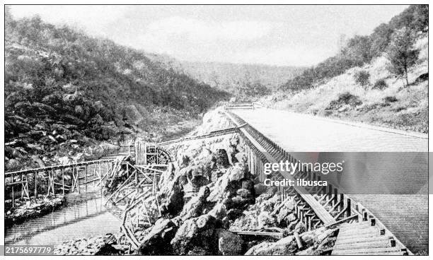 antique image: gold prospectors in california, method of raising seepage water from river bed - california gold country stock illustrations