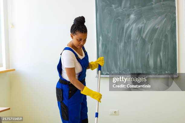 female worker preparing to tidy a classroom - mop board stock pictures, royalty-free photos & images