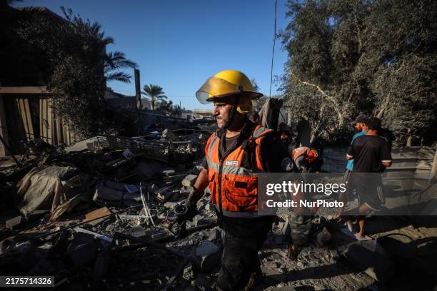 Palestinian Civil Defense rescuers attempt to extinguish fires following an Israeli airstrike in Deir al-Balah, central Gaza Strip, on October 4 amid...