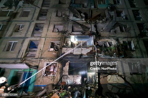 Firefighter puts out a fire in a residential building damaged by a Russian guided missile strike in Kharkiv, Ukraine, on October 3, 2024.