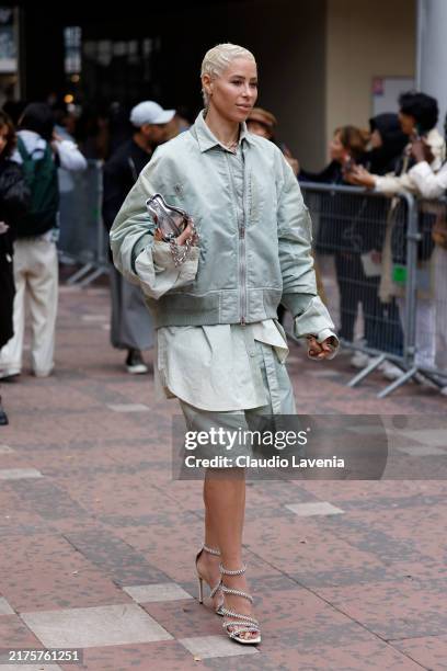 Guest wears light green jacket, matching shorts, silver bag, silver heels, outside Sacai, during Womenswear Spring/Summer 2025 as part of Paris...