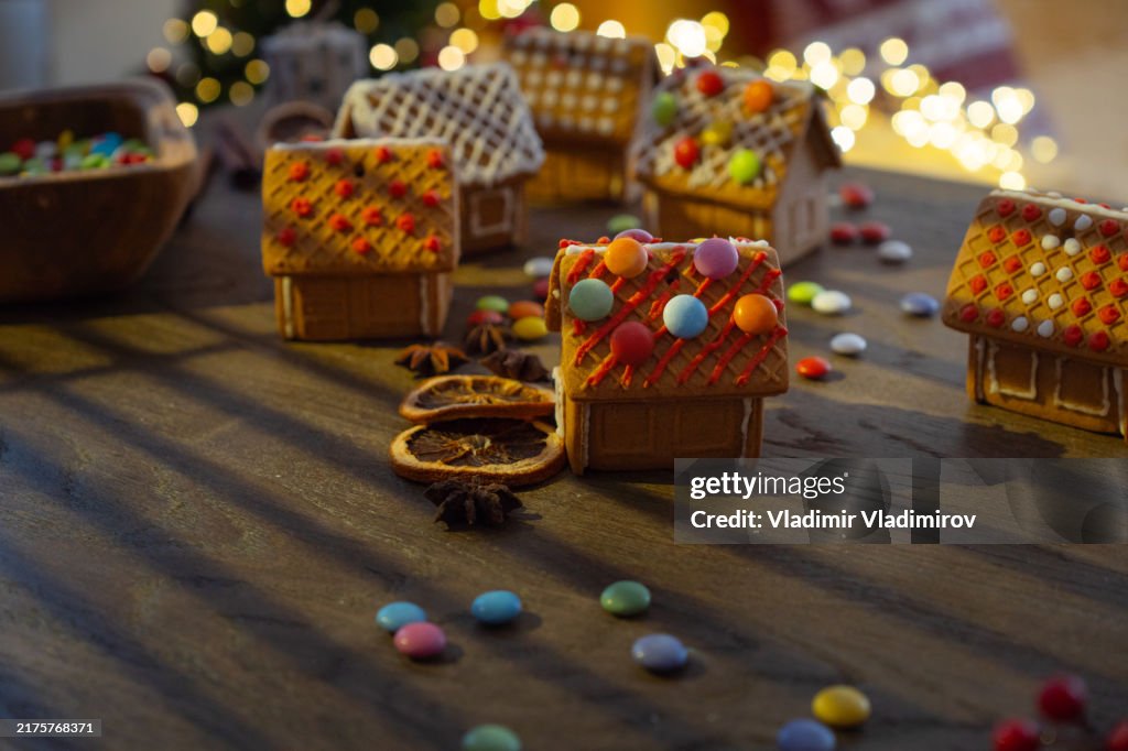 Many beautifull decorated gingerbread houses standing on the table in a cozy christmas atmosphere