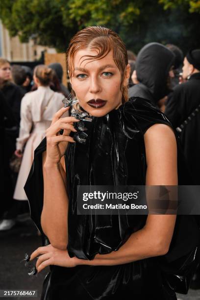 Lina Taut Dembikova is seen wearing a black long dress outside Balenciaga fashion show during Womenswear Spring/Summer 2025 as part of Paris Fashion...