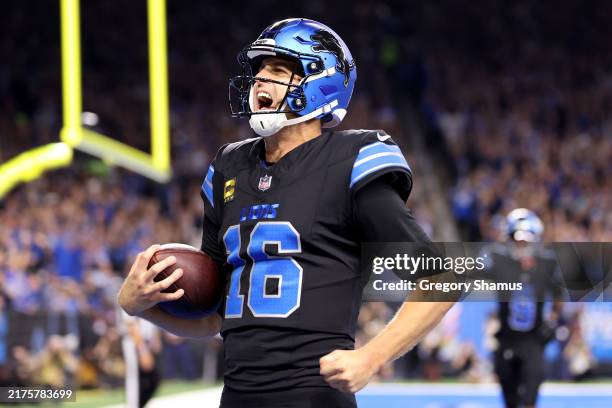 Jared Goff of the Detroit Lions celebrates after catching a touchdown pass thrown by Amon-Ra St. Brown against the Seattle Seahawks during the third...