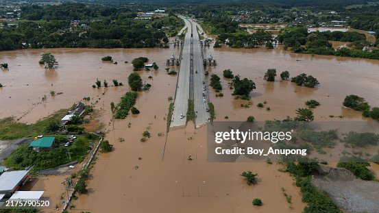Aerial view of cars stuck on the bridge while road flooded after typhoon Yagi has swept Southeast Asia. Aerial view of cars stuck on the bridge while road flooded after typhoon Yagi has swept Southeast Asia.