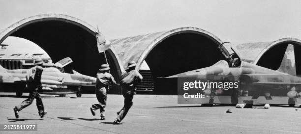 North Vietnamese soldiers of the FNL run on the tarmac of the US military airport in Tan Son Nhut, during the fall of Saigon on April 30, 1975....