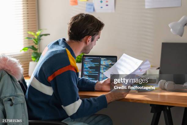 young man professional working remotely on laptop at home office. - code java script stock pictures, royalty-free photos & images