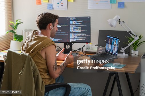 Remote Developer Engaged in Coding and Video Conference Call. Remote Developer Engaged in Coding and Video Conference Call.