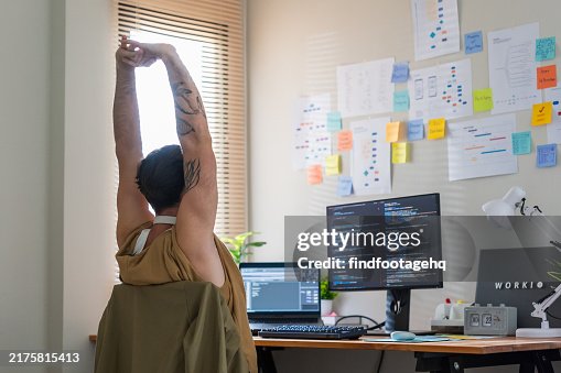 Developer Stretching in Modern Office Workspace. Developer Stretching in Modern Office Workspace.