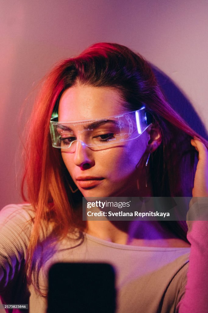 Woman in glasses with digital display uses smartphone artificial intelligence technology