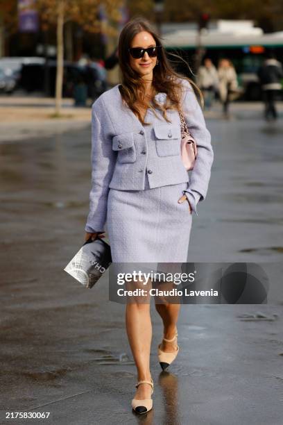 Charlotte Groeneveld wears lilac tweed jacket with matching skirt, pink Chanel bag, beige Chanel kitten heels, outside Chanel, during Womenswear...