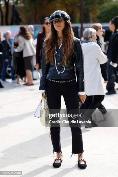 Chiara Totire wears black leather jacket, Chanel necklaces, tweed hat, black trousers, cream Chanel bag, black ballet flats, outside Chanel, during...