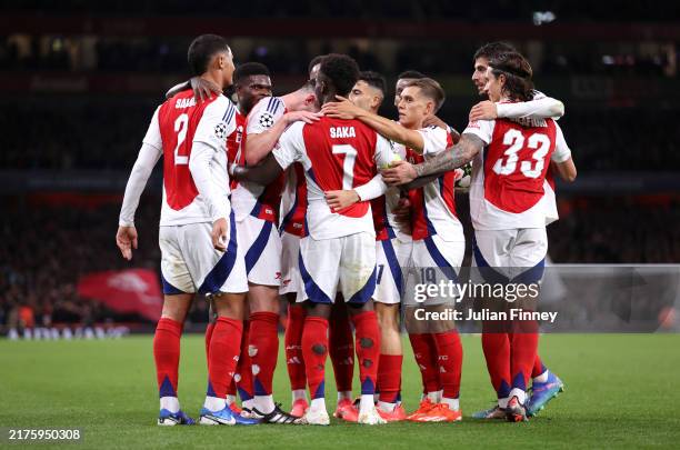 Bukayo Saka of Arsenal celebrates scoring his team's second goal with teammates during the UEFA Champions League 2024/25 League Phase MD2 match...