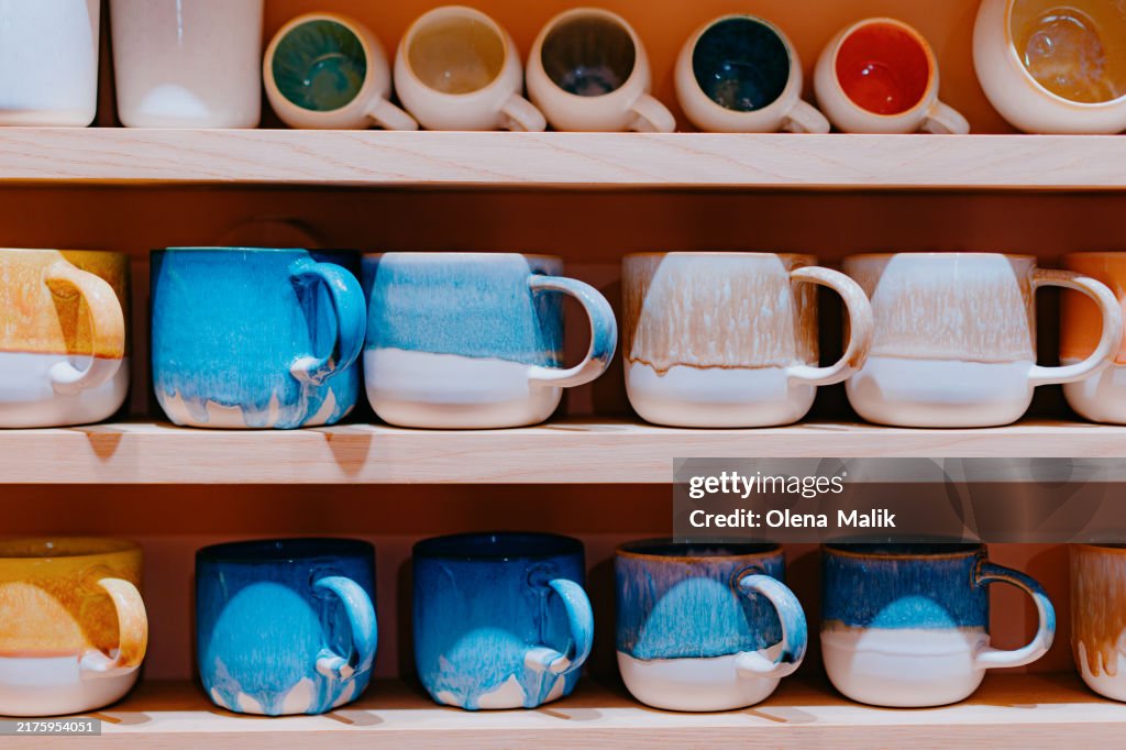 Colorful Ceramic Mugs on Wooden Shelves