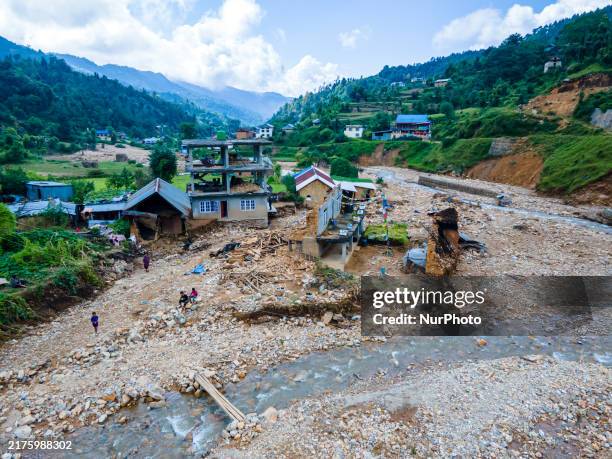 The aerial view shows the flood-affected areas of the Bhardev region of southern Lalitpur, Nepal, on October 5, 2024. Homes are severely damaged,...