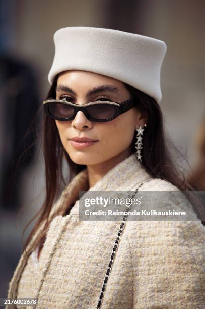 Fer Milan wears beige tweed top with matching jacket, beige shorts, beige hat and black Rocket bag outside the Chanel show during Womenswear...
