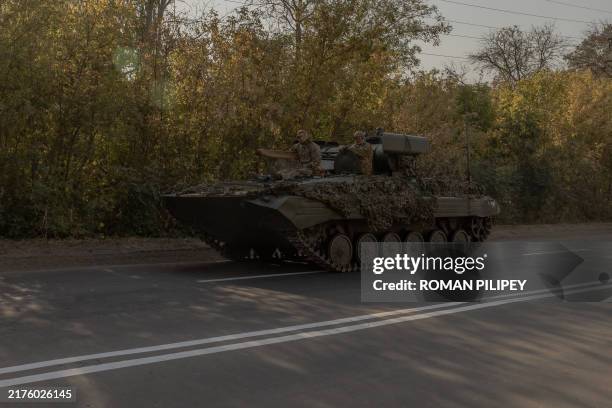 Ukrainian servicemen drive their infantry fighting vehicle on a road in the Donetsk region, on October 5 amid the Russian invasion of Ukraine.