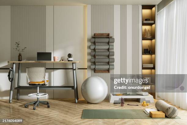 moderne zimmerausstattung mit schreibtisch, bürostuhl, laptop und sportgeräten. trainieren zu hause - pilates methode stock-fotos und bilder