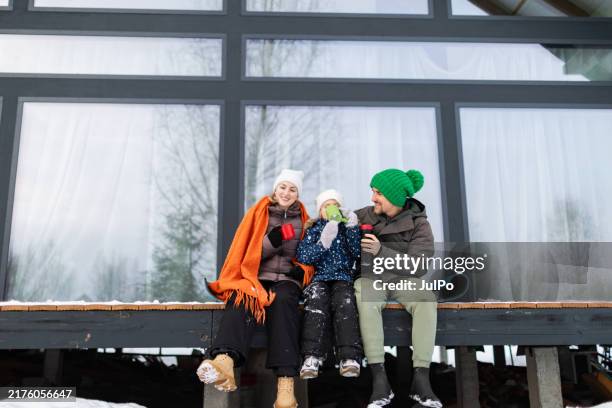 family spending time together at backyard in winter - hot drink stock pictures, royalty-free photos & images