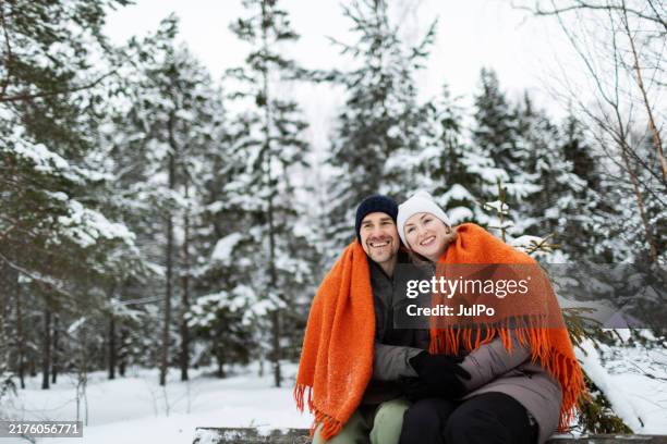 mid adult couple having fun in winter park - warm clothing stock pictures, royalty-free photos & images