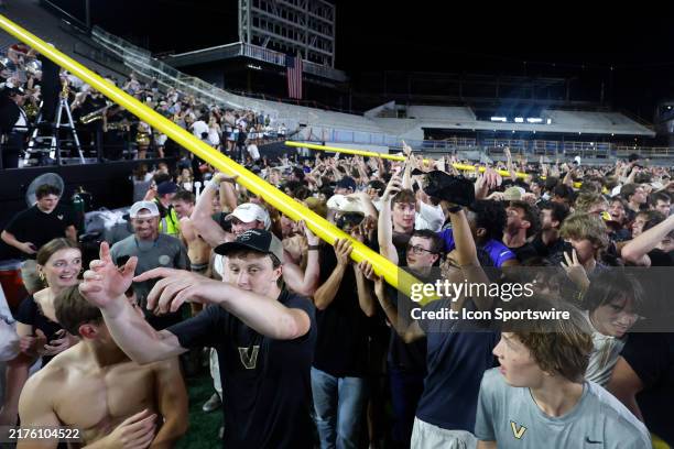 Vanderbilt Commodores fans march the goal posts around the field following a game between the Vanderbilt Commodores and Alabama Crimson Tide, October...