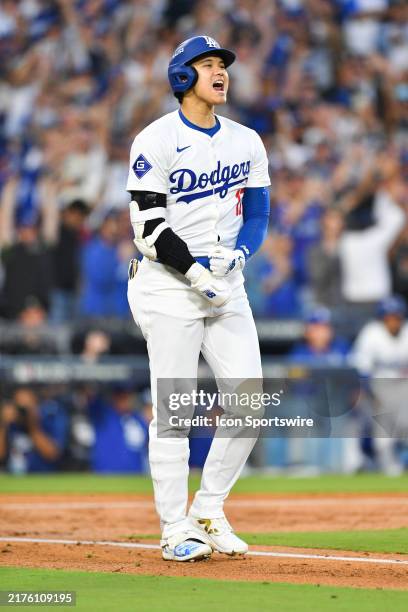 Los Angeles Dodgers designated hitter Shohei Ohtani celebrates after he hits a three run home run in the 2nd inning of game one of the National...