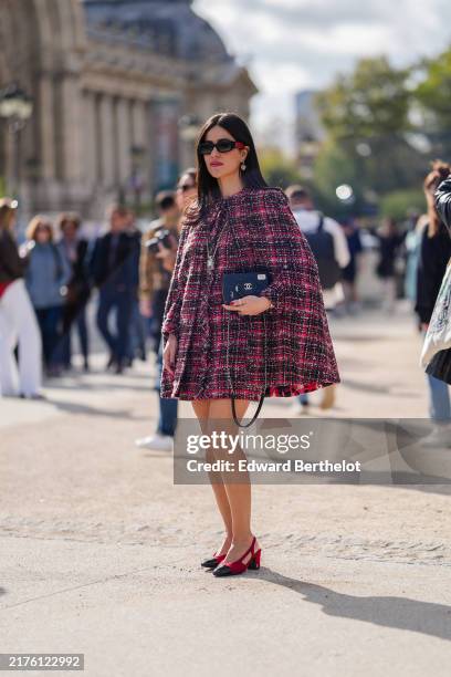 October 1: A guest wears black sunglasses, silver earrings, silver Chanel perfume bottle pendant, dark pink hot pink black pattern/plaid tweed...