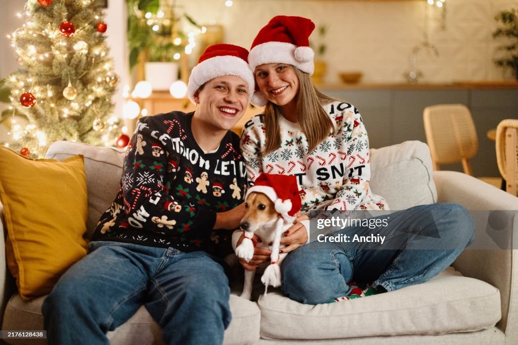 Portrait of a beautiful young couple enjoying New years Eve with their dog