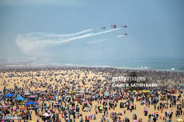 Sarang Helicopter Display Team of the Indian Air Force perform an airshow during celebrations ahead of the Indian Air Force day at Marina beach in...