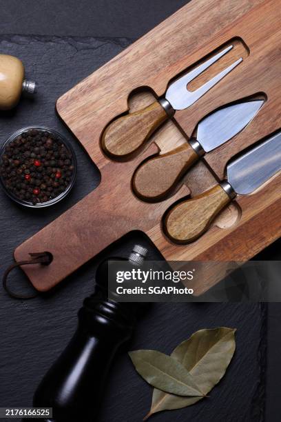 cheese board and peppers on slate background - mahogany stock pictures, royalty-free photos & images