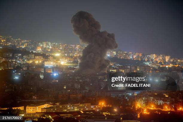 Flames and smoke rise in an area targeted by an Israeli air strike on Beirut's southern suburbs, October 5, 2024. Official Lebanese media said five...