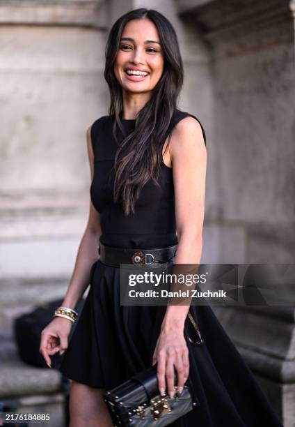 Model Kelsey Merritt is seen wearing a black Louis Vuitton dress, black belt and Louis Vuitton handbag outside the Louis Vuitton show during...