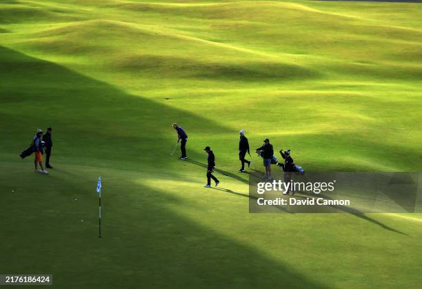The late starters in final practice reach the 18th green on The Old Course prior to the Alfred Dunhill Links Championship 2024 at the Old Course at...