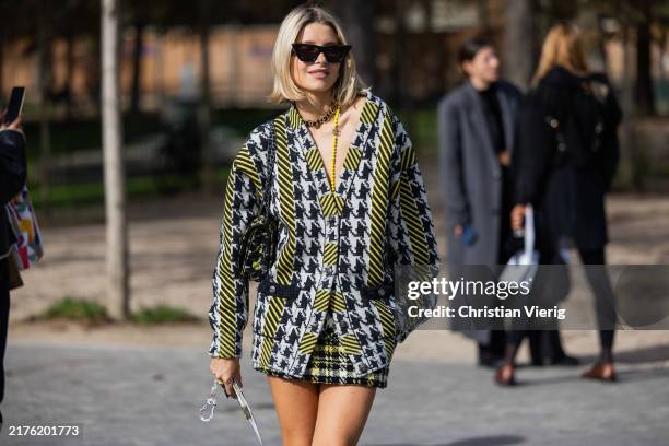 Guest wears jacket, shorts, sunglasses outside Chanel during Womenswear Spring/Summer 2025 as part of Paris Fashion Week on October 01, 2024 in...