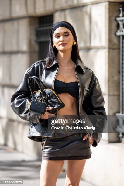 Pia Wurtzbach wears black cropped top, brown leather jacket, mini skirt outside Miu Miu during Womenswear Spring/Summer 2025 as part of Paris Fashion...