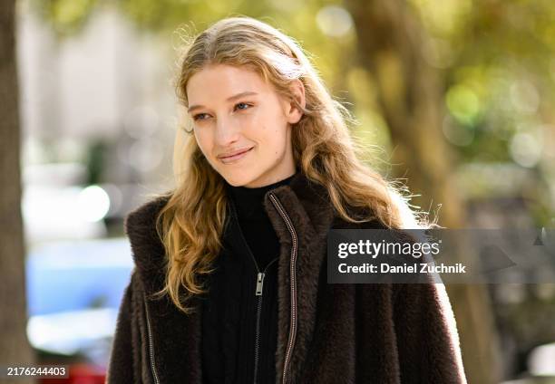 Model Apolline Rocco Fohrer is seen wearing a black jacket, black sweater outside the Miu Miu show during Womenswear Spring/Summer 2025 as part of...