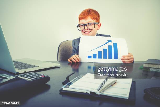 business and finance growth concept. child business man with a graph showing financial growth. - information equipment stock pictures, royalty-free photos & images
