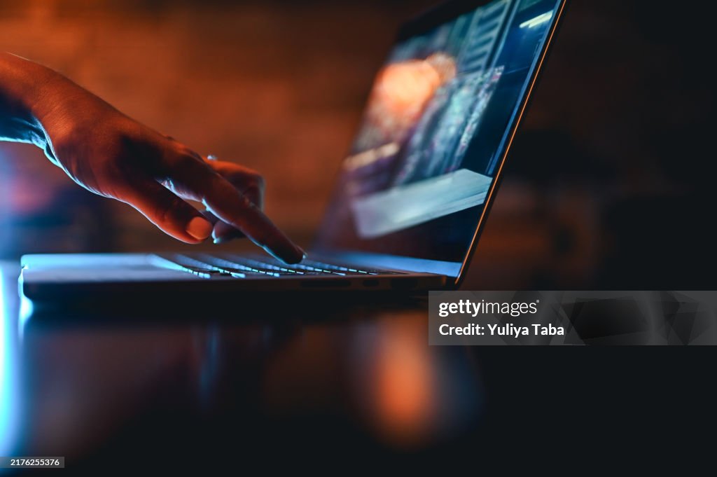 Hand typing on computer keyboard