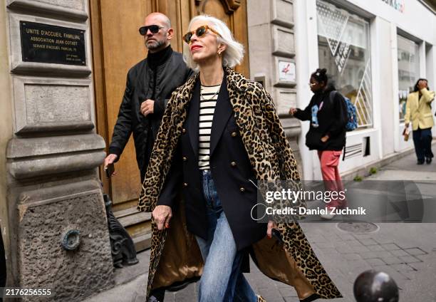 Linda Fargo is seen wearing an animal print coat, black blazer, striped shirt and blue jeans outside the Sacai show during Womenswear Spring/Summer...