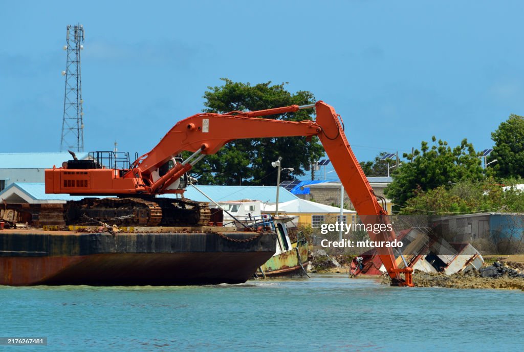 St. John's harbor - excavator digging around a sunken boat, St. John's, Antigua Island