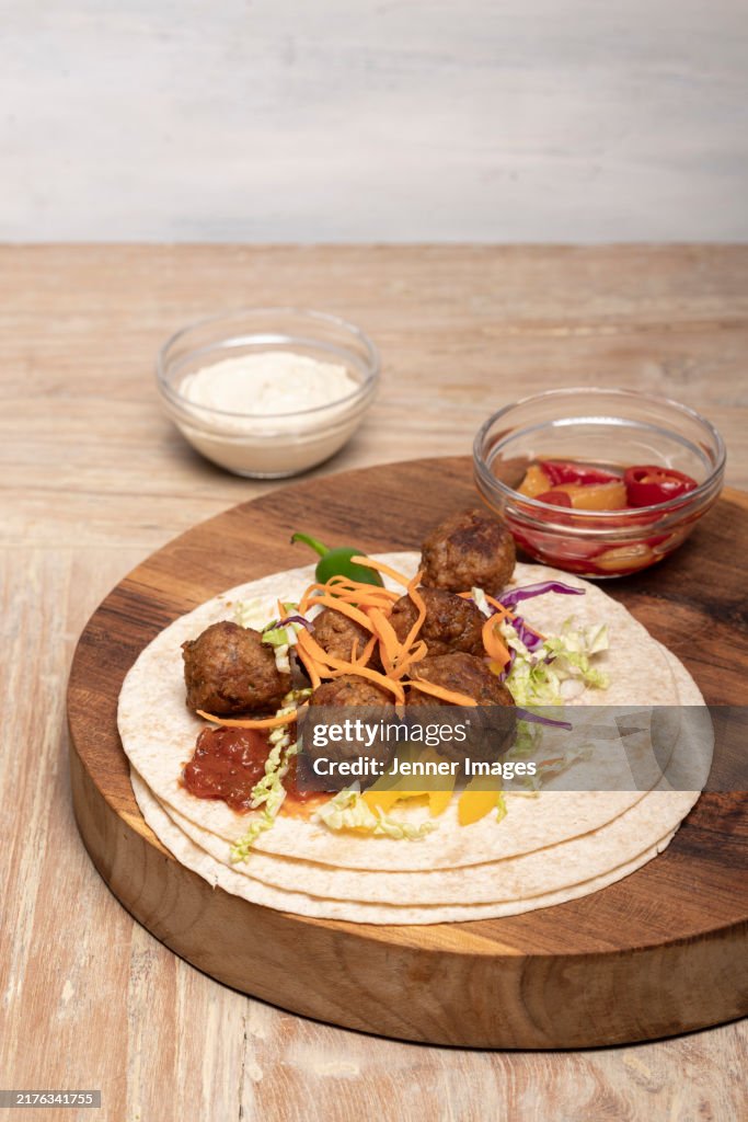 Vegan meatballs with hummus dip, flatbread and salsa sauce.