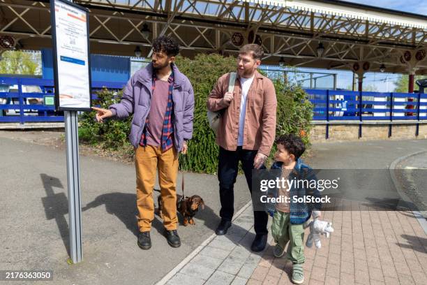 checking bus times for adventure - bus stop sign uk stock pictures, royalty-free photos & images