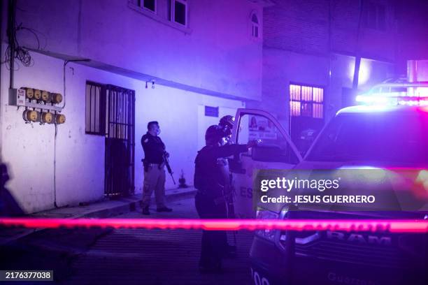 Investigators and forensic personnel work at the crime scene where remains of Chilpancingo Mayor Alejandro Arcos of the Institutional Revolutionary...