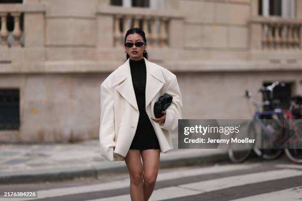 Thanya Wong seen wearing Gentle Monster black sunglasses, Polène Paris gold jewelry / earrings, Vautrait cream white oversized wool short coat /...